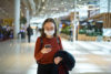 Girl with phone and mask
